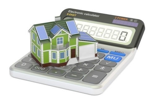 Small home with solar panels on top of a calculator