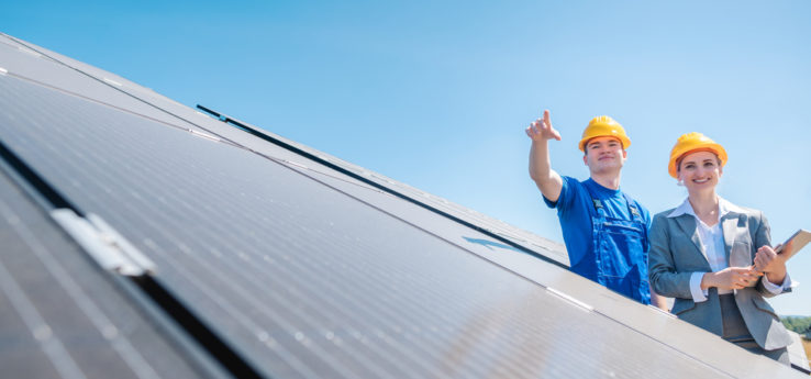 solar installers arranging where to place the solar panels