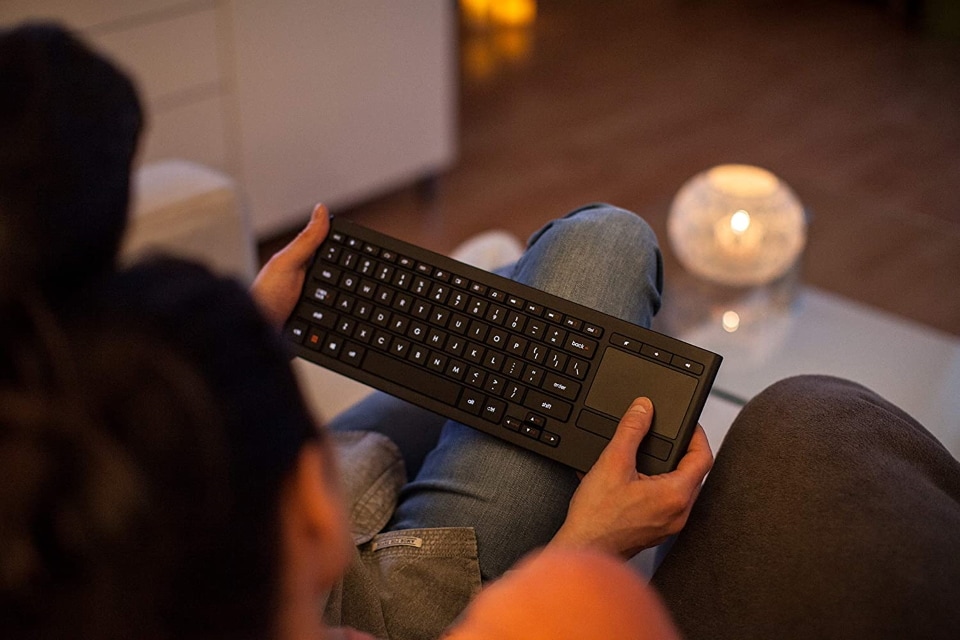 a couple using a keyboard in their living room