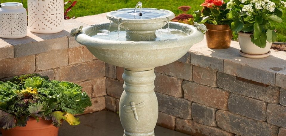 a fountain is near the pots