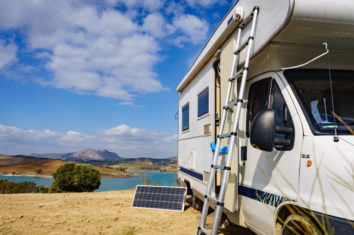 a portable solar panel next to a camper van