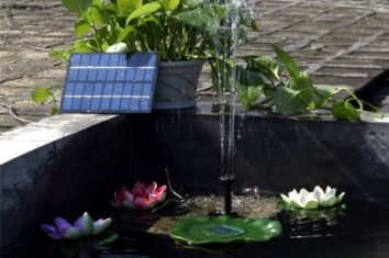 a solar powered water pump working in a small pond