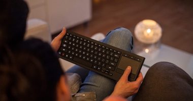 a couple using a keyboard in their living room