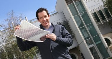 a man holding a printed solar panel