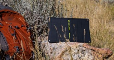 a portable solar panel on a rock