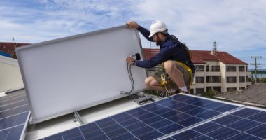 a technician disconnecting a solar panel