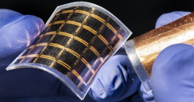 Someone with gloves holding an ultra thin-solar cell