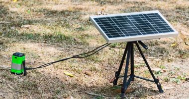 portable solar panel outdoors charging a lamp