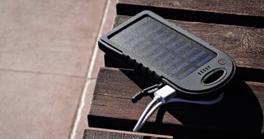 solar powered power bank on wooden table in the sun