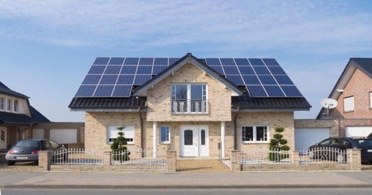 A small house that has solar panels on the roof
